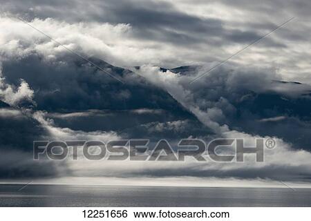 Stock Photograph - Fog over the sea in the Chilkoot Inlet; Haines, Alaska, United States of America. Fotosearch