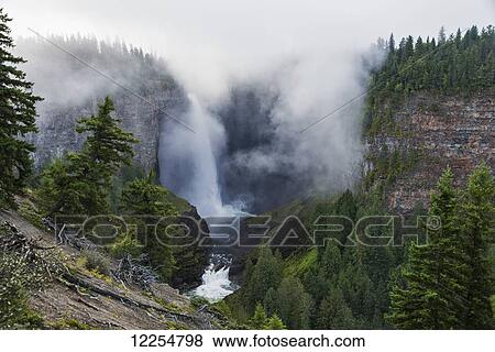 Stock Photo - Fog surrounds Helmcken Falls in Wells Gray Provincial Park, British Columbia, Canada. Fotosearch