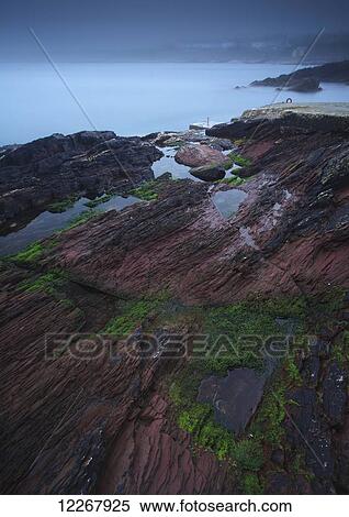 Stock Photography - Foggy coastline around Roches Point in Cork harbour; County Cork, Ireland. Fotosearch
