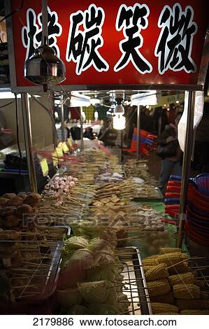 Stock Photograph - Food prepared on stall night market Taipei Taiwan. Fotosearch