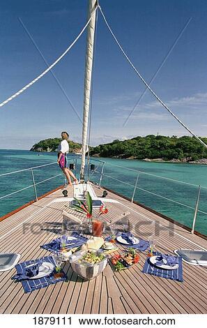Food Set On The Deck With Woman In Background On A Yacht Sailing Around The Grenadines View Large Photo Image Stock Image - Food Set On The Deck With Woman In Background On A Yacht Sailing Around The Grenadines. Fotosearch