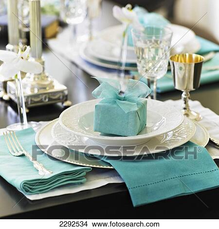 Picture - Formal table setting with white dishes and blue gift and napkins; Victoria vancouver island british columbia canada. Fotosearch