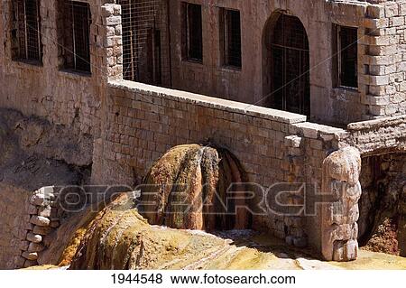 Stock Photo - Former spa by Puente del Inca, a natural arch that forms a bridge with sulphur deposits over the Vacas River, a tributary of the Mendoza River, Mendoza, Argentina. Fotosearch