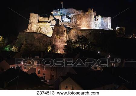 Stock Image - Fortress on a hilltop illuminated at night; Belgium. Fotosearch
