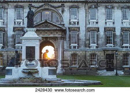 Stock Image - Founders Fountain and the Gibbs Building of King's College at dusk; Cambridge, Cambridgeshire, England. Fotosearch