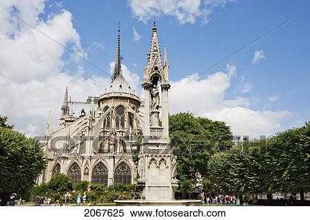Fountain Of The Virgin Behind The Apse Of Notre Dame De Paris Cathedral, With Pinnacles And Flying Buttresses, Paris, France View Large Photo Image Stock Photography - Fountain Of The Virgin Behind The Apse Of Notre Dame De Paris Cathedral, With Pinnacles And Flying Buttresses, Paris, France. Fotosearch
