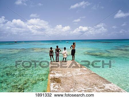 Four Boys Fishing Off Pier At Ocean View Large Photo Image Stock Image - Four Boys Fishing Off Pier At Ocean. Fotosearch
