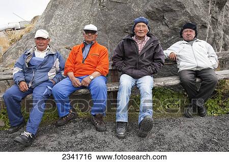 Four Inuit Men Sitting On A Bench In A Village; Kangaamiut, Greenland View Large Photo Image Stock Photograph - Four Inuit Men Sitting On A Bench In A Village; Kangaamiut, Greenland. Fotosearch