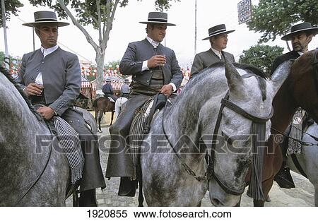 Stock Photography - Four Men On Horses At Week Long Festival, Feria. Fotosearch