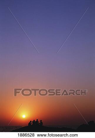 Four Men Sitting On Rocks On Beach In Silhouette, Goa View Large Photo Image Stock Photo - Four Men Sitting On Rocks On Beach In Silhouette, Goa. Fotosearch
