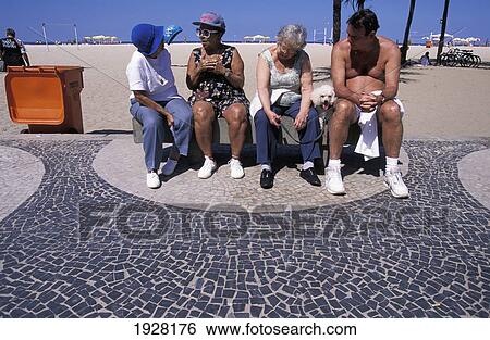 Stock Photograph - Four People On Bench, Copacabana Beach. Fotosearch