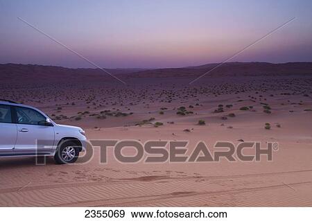 Stock Photo - Four wheel drive vehicle in the desert; Liwa Oasis, Abu Dhabi, United Arab Emirates. Fotosearch