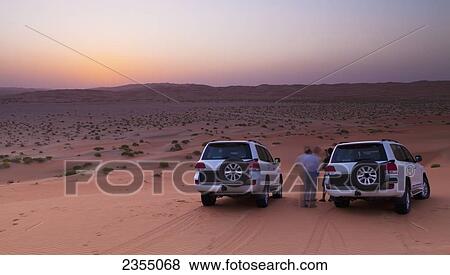 Stock Photo - Four wheel drive vehicles in the desert; Liwa Oasis, Abu Dhabi, United Arab Emirates. Fotosearch