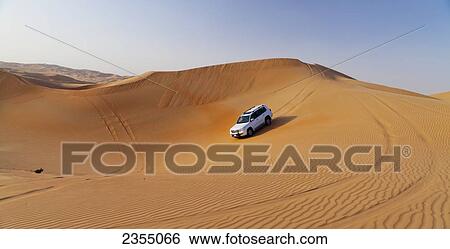 Stock Photograph - Four wheel driving in the desert; Liwa Oasis, Abu Dhabi, United Arab Emirates. Fotosearch