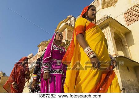 Stock Image - Four Women In Saris Walking Past Old Building. Fotosearch