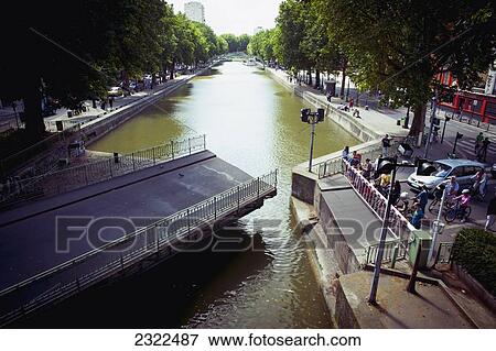 Stock Photo - France, Canal Saint Martin with crossing opening; Paris. Fotosearch