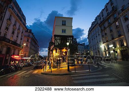 Stock Photo - France, Montmartre; Paris, Corner restaurant at dusk. Fotosearch