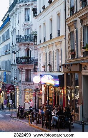 Stock Image - France, Montmartre; Paris, People enjoying summer evening at sidewalk cafe. Fotosearch