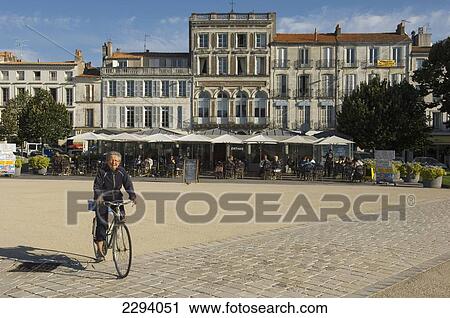 France, Poitou-Charentes, Woman cyclist passing pavement cafes; Rochefort View Large Photo Image Stock Image - France, Poitou-Charentes, Woman cyclist passing pavement cafes; Rochefort. Fotosearch