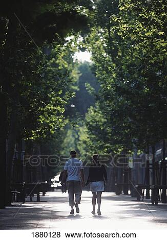 Stock Photo - France, Provence, Couple Walking Down Street; Avignon. Fotosearch