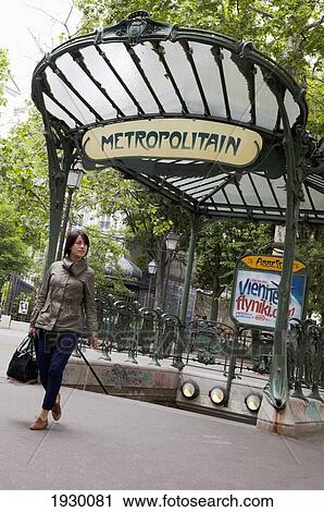 France, Woman walking in front of Metro Station sign; Paris View Large Photo Image Stock Image - France, Woman walking in front of Metro Station sign; Paris. Fotosearch