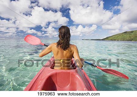 Stock Image - French Polynesia, Bora Bora, Female Kayaker Enjoying A Day On The Water.. Fotosearch
