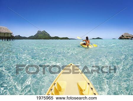 Stock Photography - French Polynesia, Bora Bora, Female Kayaker Enjoying A Day On The Water.. Fotosearch