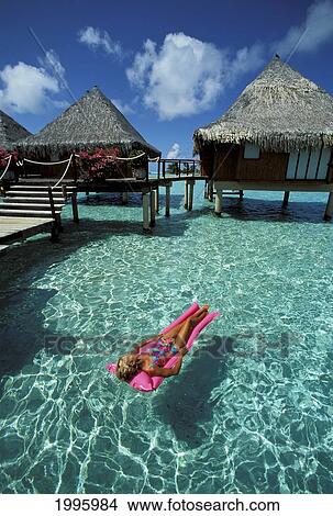French Polynesia, Bora Bora, Hotel Moana Resort, Woman Lying On Inflatable Raft Near View Large Photo Image Picture - French Polynesia, Bora Bora, Hotel Moana Resort, Woman Lying On Inflatable Raft Near. Fotosearch