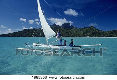 French Polynesia, Bora Bora, Local People In Outrigger Sailing Canoe, Beautiful Turquoise Ocean. View Large Photo Image Stock Photograph - French Polynesia, Bora Bora, Local People In Outrigger Sailing Canoe, Beautiful Turquoise Ocean.. Fotosearch