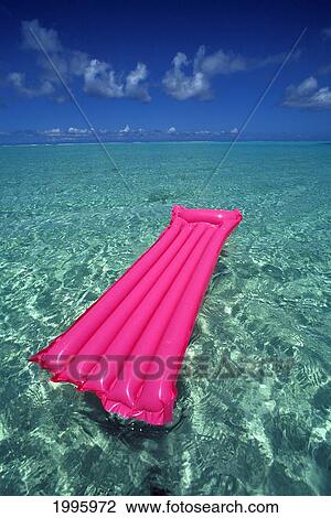 Stock Image - French Polynesia, Bora Bora, Pink Inflated Raft On Clear Ocean Water Seen From Bora Bora Lagoon.. Fotosearch