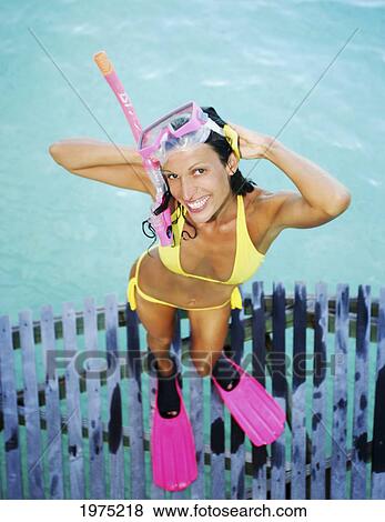 Stock Photo - French Polynesia, Bora Bora, Woman Stands On A Dock And Poses For The Camera.. Fotosearch