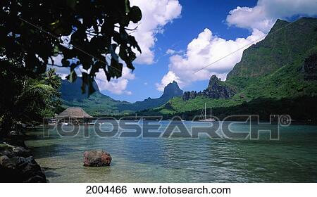 Stock Photograph - French Polynesia, Moorea, Cooks Bay Looking Into Scenic Landscape Mount Rotui Distant Background Panoramic Widelux. Fotosearch