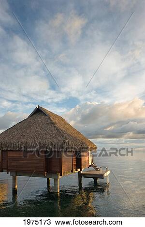 Stock Image - French Polynesia, Moorea Lagoon Resort, Bungalows Over Beautiful Turquoise Ocean.. Fotosearch
