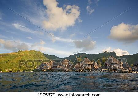 Stock Photo - French Polynesia, Moorea Lagoon Resort, Bungalows Over Beautiful Turquoise Ocean.. Fotosearch