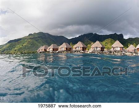 French Polynesia, Moorea Lagoon Resort, Bungalows Over Beautiful Turquoise Ocean. View Large Photo Image Stock Photo - French Polynesia, Moorea Lagoon Resort, Bungalows Over Beautiful Turquoise Ocean.. Fotosearch