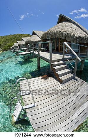 French Polynesia, Moorea, Luxury Resort Bungalows Over Ocean. View Large Photo Image Picture - French Polynesia, Moorea, Luxury Resort Bungalows Over Ocean.. Fotosearch