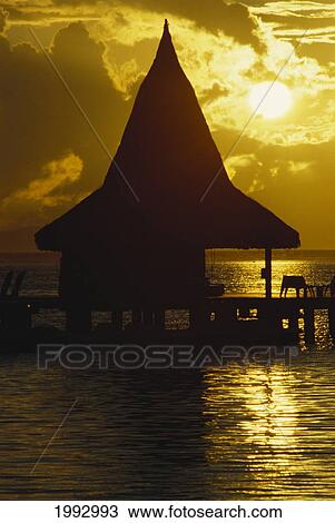 French Polynesia, Moorea, Silhouette Of Bungalow At Sunrise. View Large Photo Image Stock Image - French Polynesia, Moorea, Silhouette Of Bungalow At Sunrise.. Fotosearch