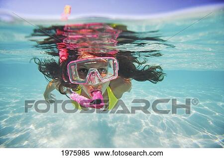 Stock Photography - French Polynesia, Moorea, Woman Free Diving In Turquoise Ocean.. Fotosearch