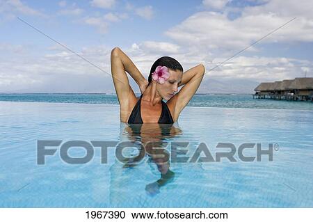 French Polynesia, Moorea, Woman Relaxing In Oceanside Resort Pool. View Large Photo Image Stock Image - French Polynesia, Moorea, Woman Relaxing In Oceanside Resort Pool.. Fotosearch