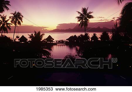 Stock Image - French Polynesia, Papeete, Tahiti Beachcomber Hotel Silhouetted At Sunset.. Fotosearch