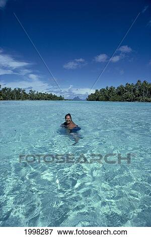 French Polynesia, Tahaa, Woman Cools Off In Waters Between Motu View Large Photo Image Stock Photo - French Polynesia, Tahaa, Woman Cools Off In Waters Between Motu. Fotosearch