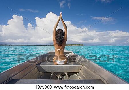 Stock Image - French Polynesia, Tahiti, Bora Bora, Woman Sitting In Boat.. Fotosearch