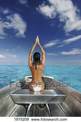 Stock Photo - French Polynesia, Tahiti, Bora Bora, Woman Sitting In Boat.. Fotosearch