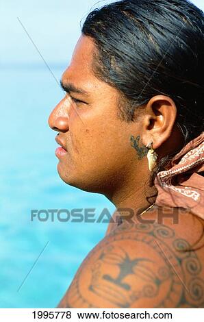 Stock Photo - French Polynesia, Tahiti, Huahine, Tahitian Man With Tattoos, View From Side. Fotosearch