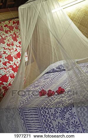 French Polynesia, Tahiti, Maupiti, Hotel Bedroom With Flowers On Bed. View Large Photo Image Stock Image - French Polynesia, Tahiti, Maupiti, Hotel Bedroom With Flowers On Bed.. Fotosearch