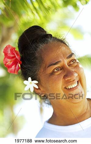 Stock Photo - French Polynesia, Tahiti, Maupiti, Local Women With Flowers.. Fotosearch