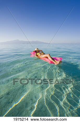 Picture - French Polynesia, Tahiti, Moorea, Woman Floating In Water.. Fotosearch