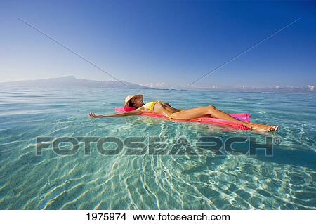 Picture - French Polynesia, Tahiti, Moorea, Woman Floating In Water.. Fotosearch