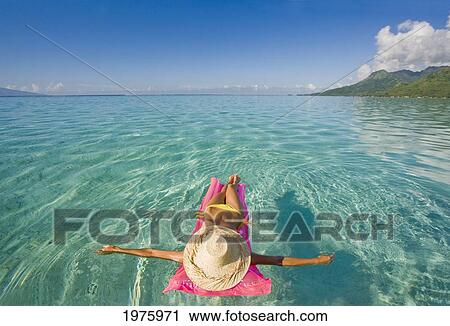 French Polynesia, Tahiti, Moorea, Woman Floating In Water. View Large Photo Image Stock Image - French Polynesia, Tahiti, Moorea, Woman Floating In Water.. Fotosearch