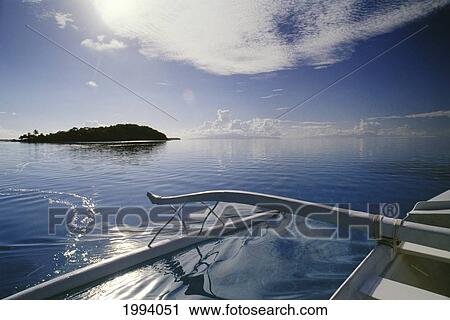Stock Image - French Polynesia, Tahiti, Outrigger In Coral Waters Of Bora Bora, Motu In Background. Fotosearch
